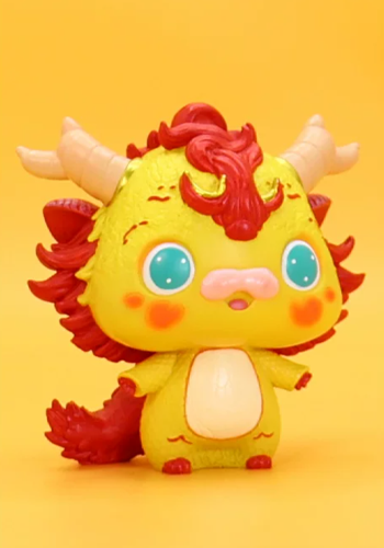 Front view of the yellow Baishao dragon figure with red mane and blue eyes