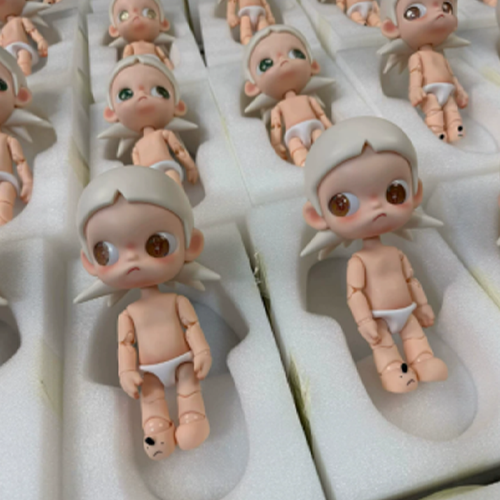 Articulated doll bodies arranged in protective foam packaging trays