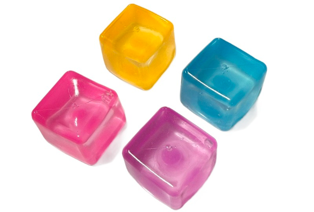 Four translucent colorful TPR ice cube slow-rising squishy toys in pink, purple, blue and yellow
